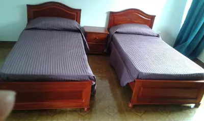 two beds sitting next to each other in a room at Casa Amarela in Ponta do Sol