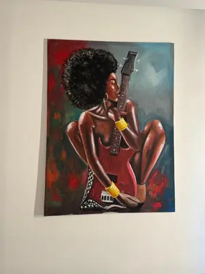 a painting of a black woman playing a guitar at SGC Boa Vista Apartments in Sal Rei