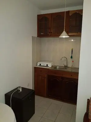 a small kitchen with a sink and a stove at Pensão Alcinda Bettencourt 50 meters to the Beachfront in Santa Maria