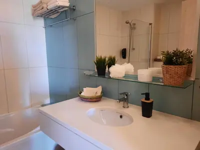 a bathroom with a sink and a mirror at Guesthouse Le Châtelain in Santa Maria