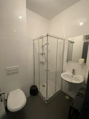 a bathroom with a shower and a toilet and a sink at Morabezahome in Mindelo