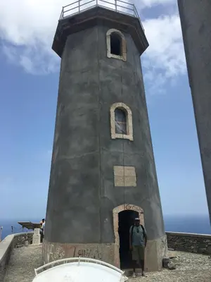 a man standing in front of a lighthouse at Guest House Frontera in Pinto
