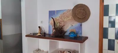 a shelf in a room with a picture on the wall at Casa Verde in Mindelo