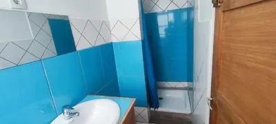 a blue bathroom with a sink and a shower at Casa Verde in Mindelo