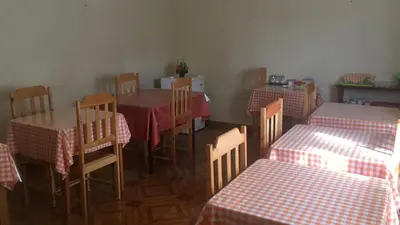 a dining room with two tables and a table and chairs at Sissi's B&B in Ponta do Sol