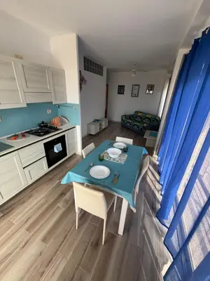 a small kitchen and living room with a blue table at KA ANGELA, WI-FI FREE Praia Cabral, Sal Rei in Sal Rei