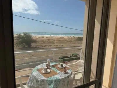 a room with a table and a view of the beach at KA ANGELA, WI-FI FREE Praia Cabral, Sal Rei in Sal Rei