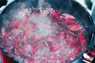 a pot full of strawberries in a pot of water at Dunas De Areia Preta in Ribeira da Prata