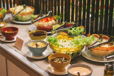 a buffet with many bowls of food on a table at Halos Casa Resort in Santa Maria