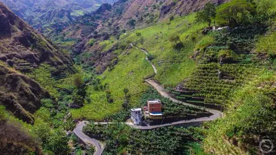 a truck driving down a winding mountain road at casa xoxo in Ribeira Grande