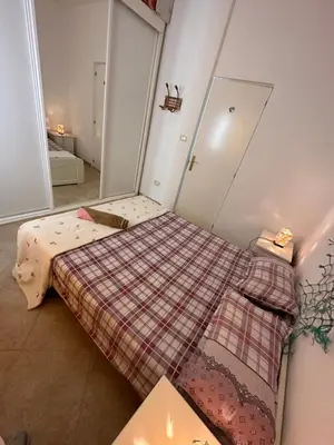 a small bedroom with a bed with a plaid blanket at sea View Nautilus free wi-fi Sal Rei in Sal Rei