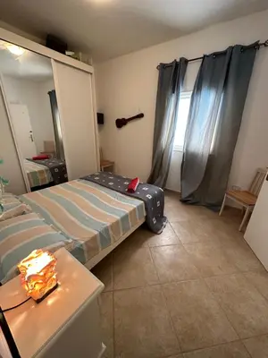 a bedroom with two beds and a table and a window at sea View Nautilus free wi-fi Sal Rei in Sal Rei