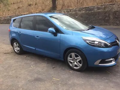 a blue car parked on the side of a road at Aparthotel Praiano in Praia