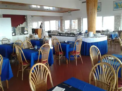 a dining room with blue tables and chairs at Solmar apartment in Beirona