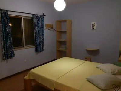 a bedroom with a bed and a window at Casa Tabanka Apartment in Tarrafal