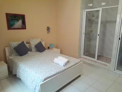 a bedroom with a bed and a glass shower at POUSADA O RECANTO in Paul