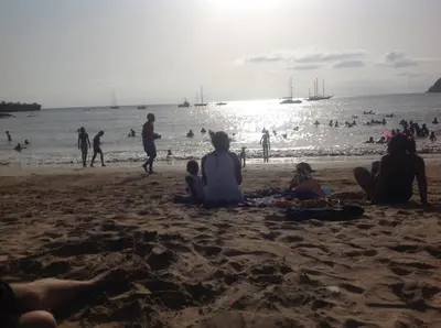 a group of people sitting on the beach at Casa Cabral : Big Apartment next to the beach in Tarrafal