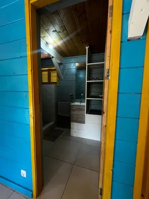 a bathroom in a house with a blue wall at Casa Madeira in Porto Novo