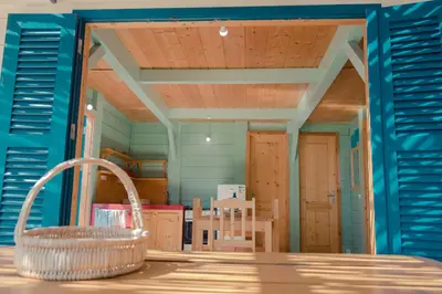 a room with blue walls and a table and chairs at Casa Madeira in Porto Novo