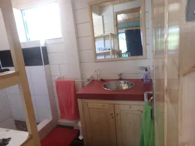 a small bathroom with a sink and a mirror at Casa Madeira in Porto Novo