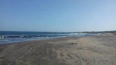 an empty beach with the ocean in the background at Casa Madeira in Porto Novo