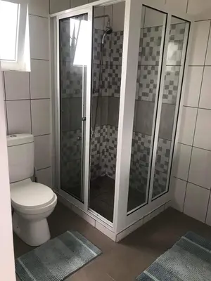 a bathroom with a toilet and a glass shower at Villa Vicente in Vila Nova Sintra