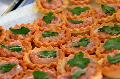 a bunch of orange food with green leaves on it at Porto Antigo Top 10 in Santa Maria