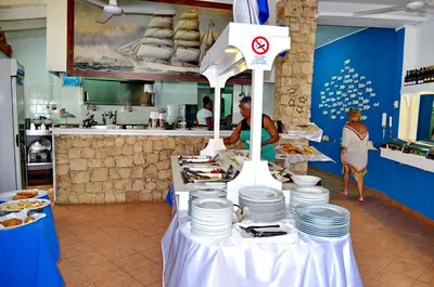 a table with plates on it in a kitchen at Porto Antigo Top 10 in Santa Maria