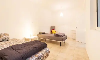 a bedroom with two beds in a room at Casa Io - Bica in Mindelo