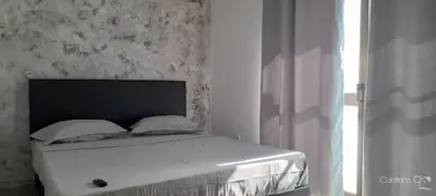 a bedroom with a bed with white sheets and a window at Cantinho C - Alojamento Complementar in Praia