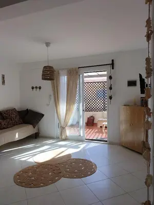 a living room with a door open to a patio at Blue Ocean in Santa Maria
