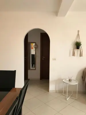 a hallway with a table and a door at Blue Ocean in Santa Maria