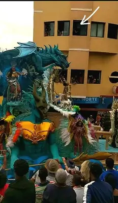a group of people watching a dragon performance at Avenida Dr Baltazar Lopes da Silva 33A in Mindelo