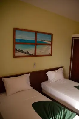 two beds in a room with two windows at Misturod - Holiday Apartments in Santa Maria