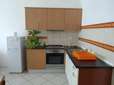 a small kitchen with a stove and a refrigerator at Good value low cost apartment second beach line in Santa Maria