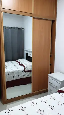 a bedroom with a mirror with a bed in it at Jessica Appartment in Praia