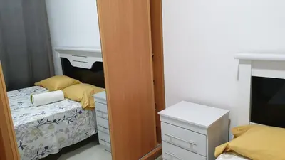 a bedroom with two beds and a mirror at Jessica Appartment in Praia