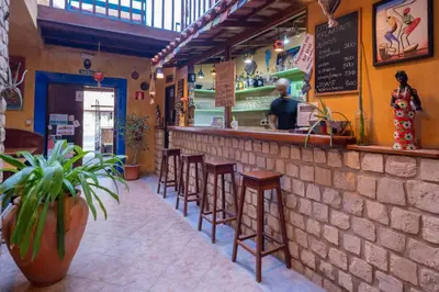 a row of stools at a bar in a restaurant at Sakaroule B&B in Santa Maria