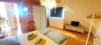 a bedroom with a bed and a tv in it at Beach penthouse with rooftopbar and Fiber WiFi, spectacular 180 degrees ocean view in Santa Maria