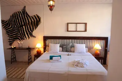 a bedroom with a bed with two stuffed animals on it at Casa Colonial Koenig in São Filipe