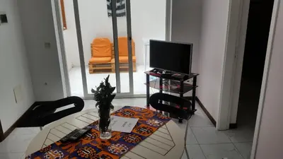 a living room with a table and a television at ka-Bela in Sal Rei