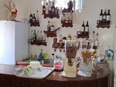 a kitchen counter with two vases on a table at Residencial Vitoria in Ponta do Sol