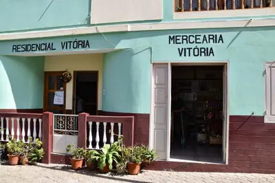 a store front of a building with potted plants in front at Residencial Vitoria in Ponta do Sol
