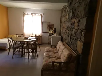 a living room with a couch and a table at Chambre indépendante in Porto Novo