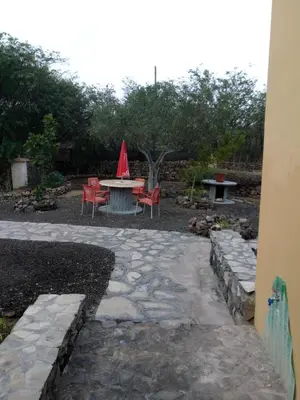 a patio with a table and chairs in a yard at Chambre indépendante in Porto Novo