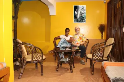 two people sitting at a table in a room at O Jardim do Vinho, AC in Praia