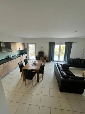 a living room with a black couch and a table at Apartment in Vila Verde - Pool view - Santa Maria in Santa Maria