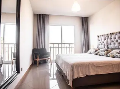 a bedroom with a bed and a chair and a mirror at BIA D'Olaf Apartments in Santa Maria