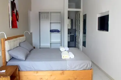 a bedroom with a bed with two towels on it at Residence A Paz in Boa Ventura