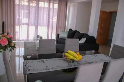 a table with a bowl of fruit on it in a living room at Apartamentos DECOR in Tarrafal